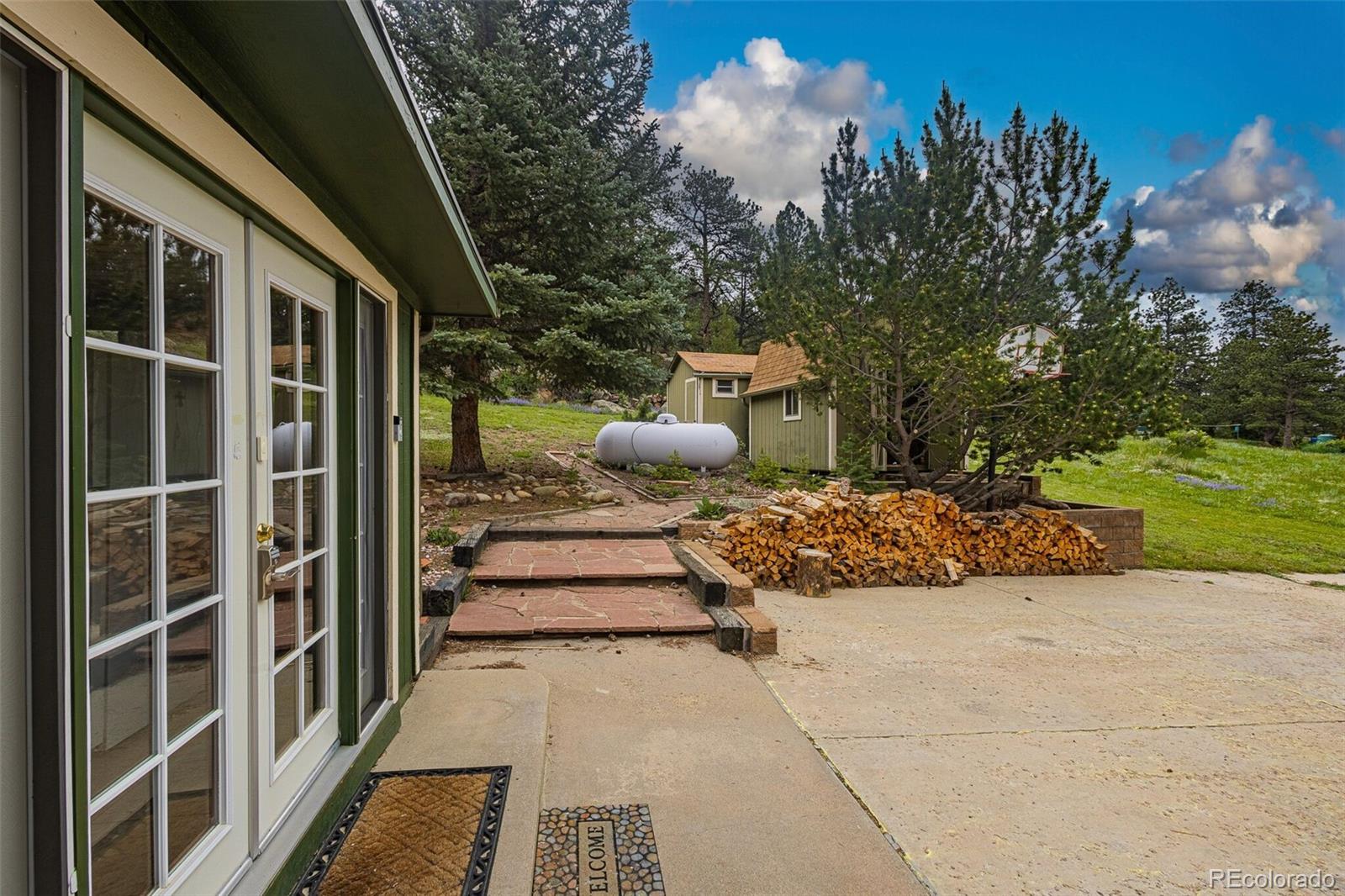 98 Button Rock Road Lyons, CO 80540 - Photo 31 of 40 a view of a porch with furniture and a yard