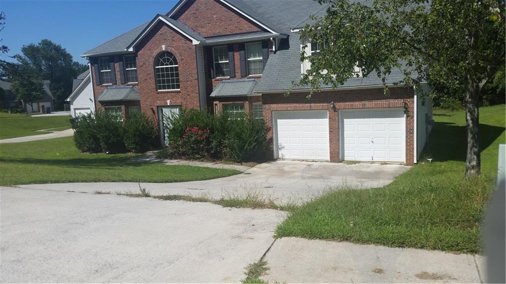 652 Tomahawk Place Southwest Austell, GA 30168 - Photo 1 of 1 a front view of a house with a yard and garage
