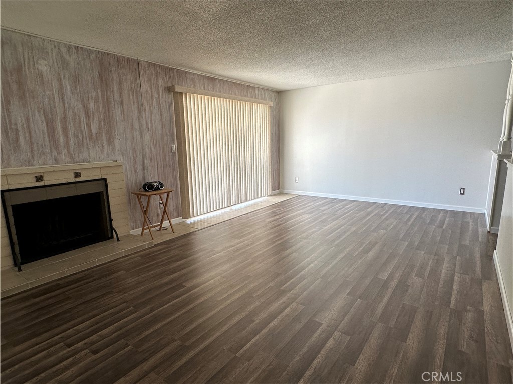 1624 Forane Street Barstow, CA 92311 - Photo 11 of 30 an empty room with wooden floor and fireplace