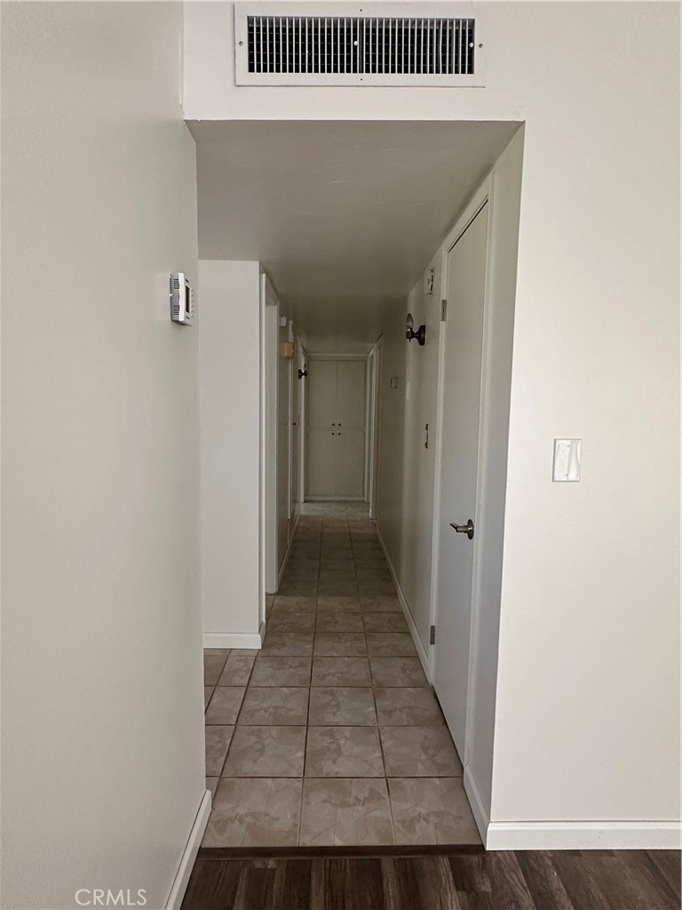 1624 Forane Street Barstow, CA 92311 - Photo 13 of 30 a view of a hallway with wooden floor and a bathroom