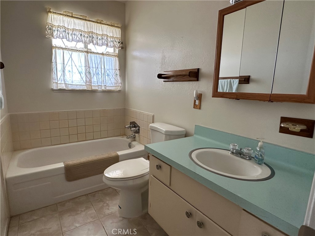 1624 Forane Street Barstow, CA 92311 - Photo 14 of 30 a bathroom with a sink toilet a tub and vanity