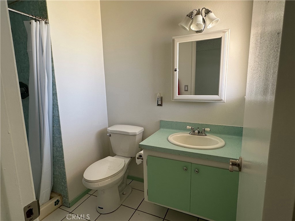 1624 Forane Street Barstow, CA 92311 - Photo 21 of 30 a bathroom with a toilet sink and mirror