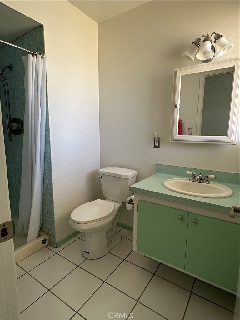 1624 Forane Street Barstow, CA 92311 - Photo 23 of 30 a bathroom with a toilet sink and mirror