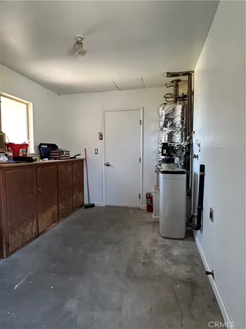 a view of a storage & utility room with two washing machine