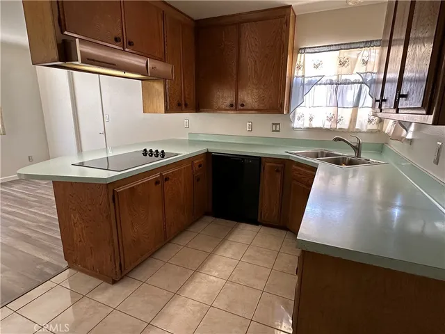 a kitchen with stainless steel appliances granite countertop a sink stove and a refrigerator