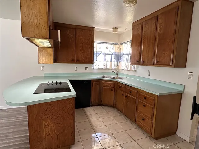 a kitchen with a sink stove top oven and cabinets