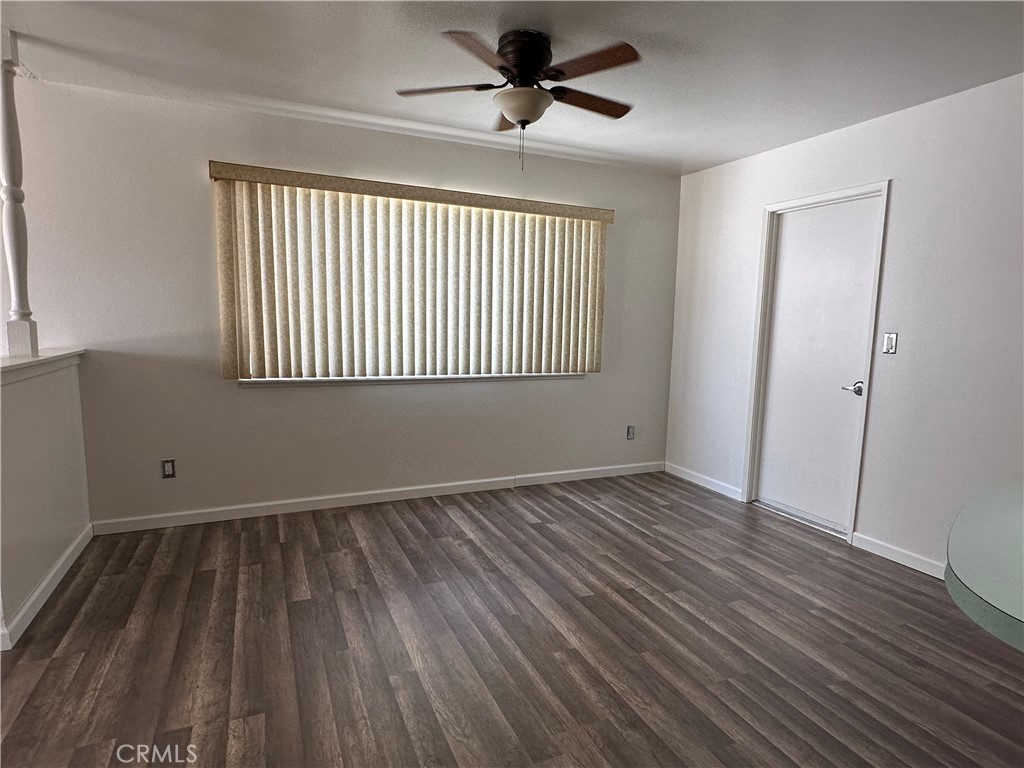 1624 Forane Street Barstow, CA 92311 - Photo 9 of 30 a view of an empty room with wooden floor and a window