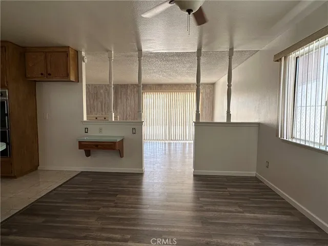 a view of kitchen with wooden floor and electronic appliances
