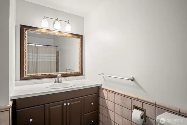 a bathroom with a sink vanity and a mirror