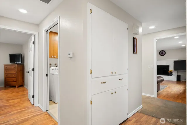 a view of a hallway with wooden floor