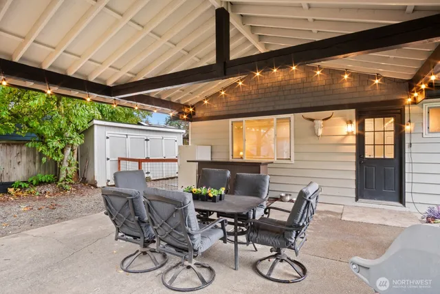 a view of a patio with table and chairs and potted plants