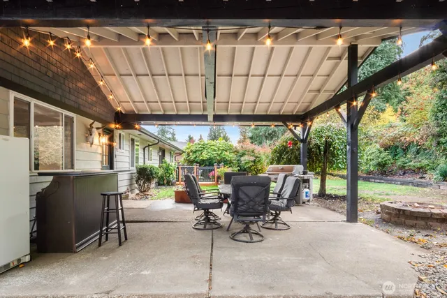 a view of patio with table and chairs and potted plants