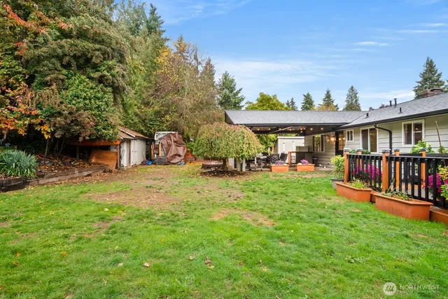 a backyard of a house with barbeque oven table and chairs