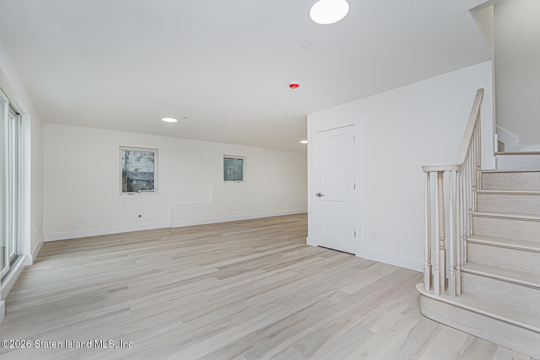 54 Cedarcliff Road Staten Island, NY 10301 - Photo 37 of 49 wooden floor in an empty room with a window