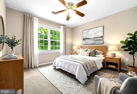 a bedroom with bed couch and window
