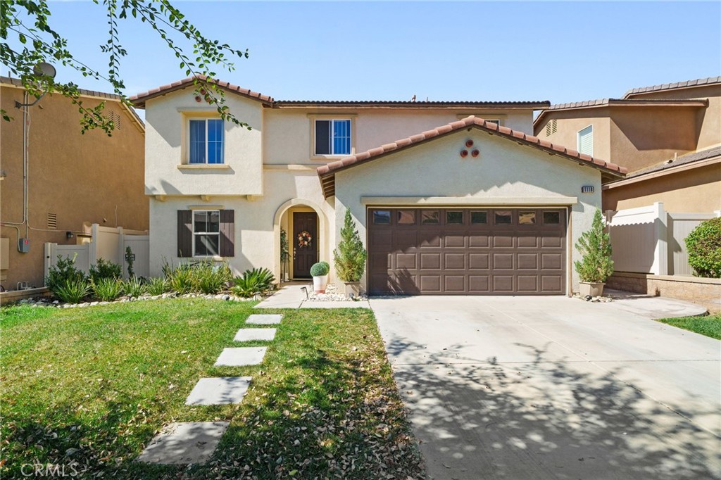 1118 North Iris Avenue Rialto, CA 92376 - Photo 1 of 1 a front view of a house with a yard and garage