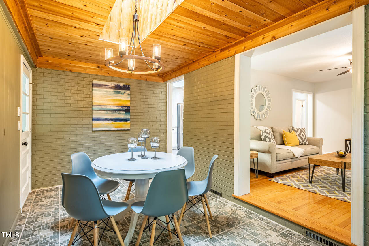 210 Landsbury Drive Durham, NC 27707 - Photo 11 of 20 a view of a dining room with furniture a rug and wooden floor