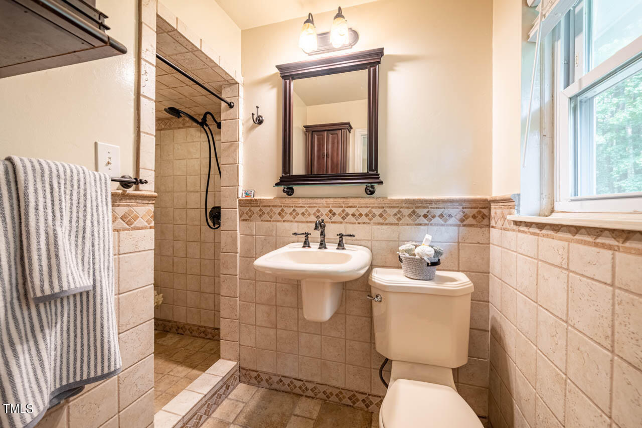 210 Landsbury Drive Durham, NC 27707 - Photo 18 of 20 a bathroom with a toilet sink and mirror