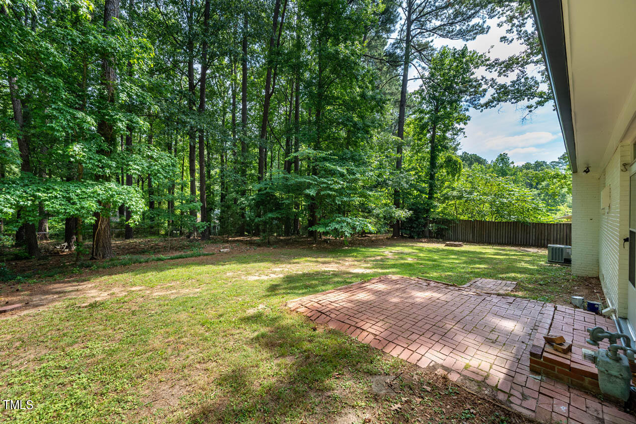 210 Landsbury Drive Durham, NC 27707 - Photo 19 of 20 a view of a backyard with large trees