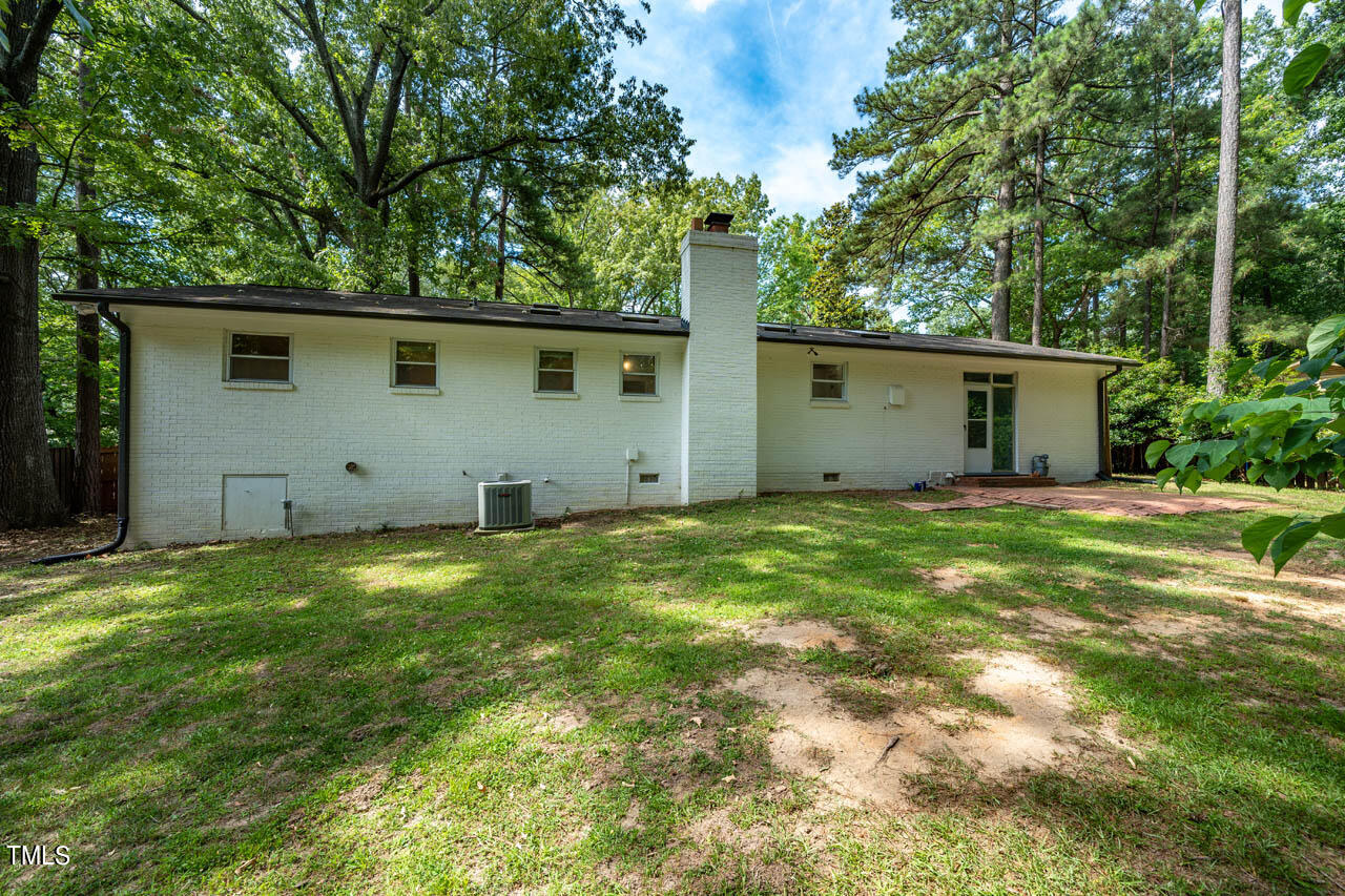 210 Landsbury Drive Durham, NC 27707 - Photo 20 of 20 a view of a backyard with potted plants and large trees