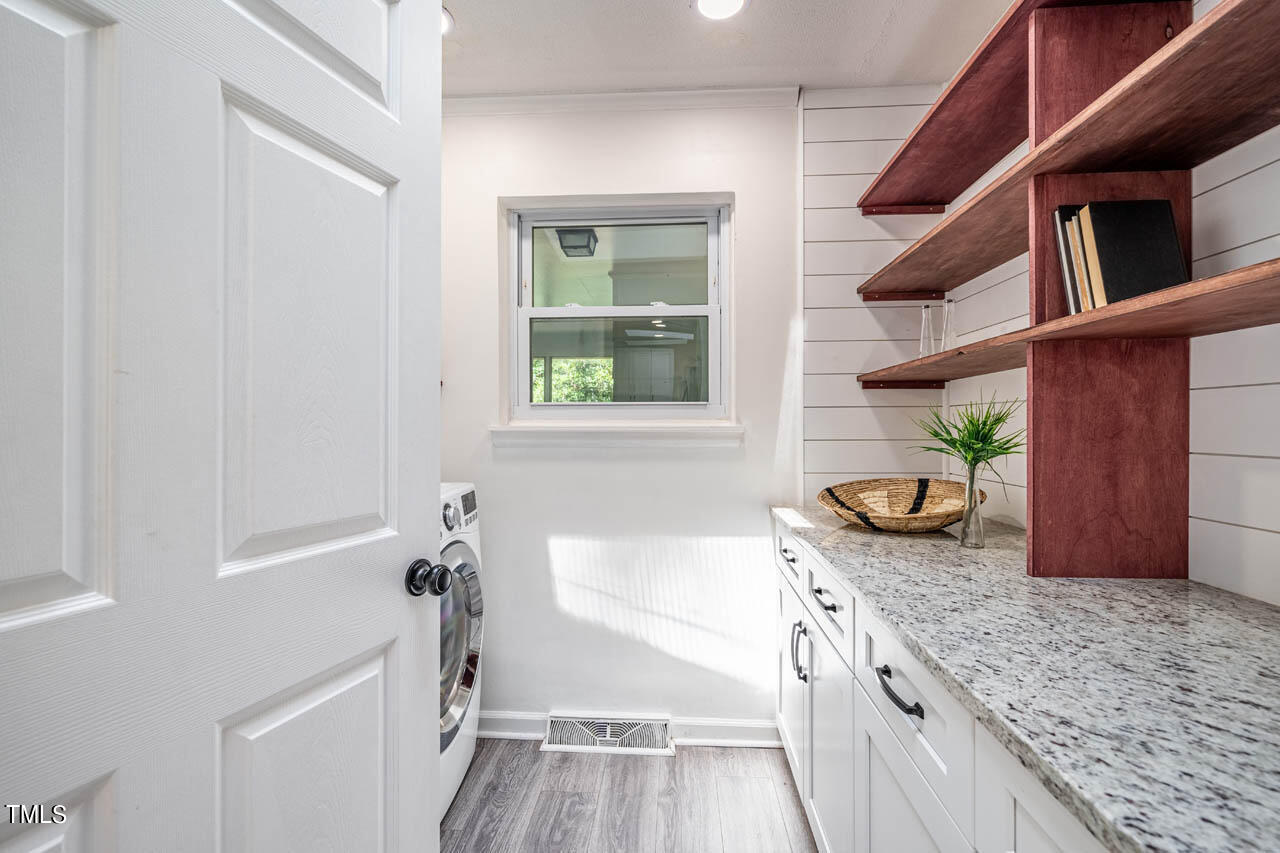 210 Landsbury Drive Durham, NC 27707 - Photo 7 of 20 a bathroom with a granite countertop sink a toilet and bathtub