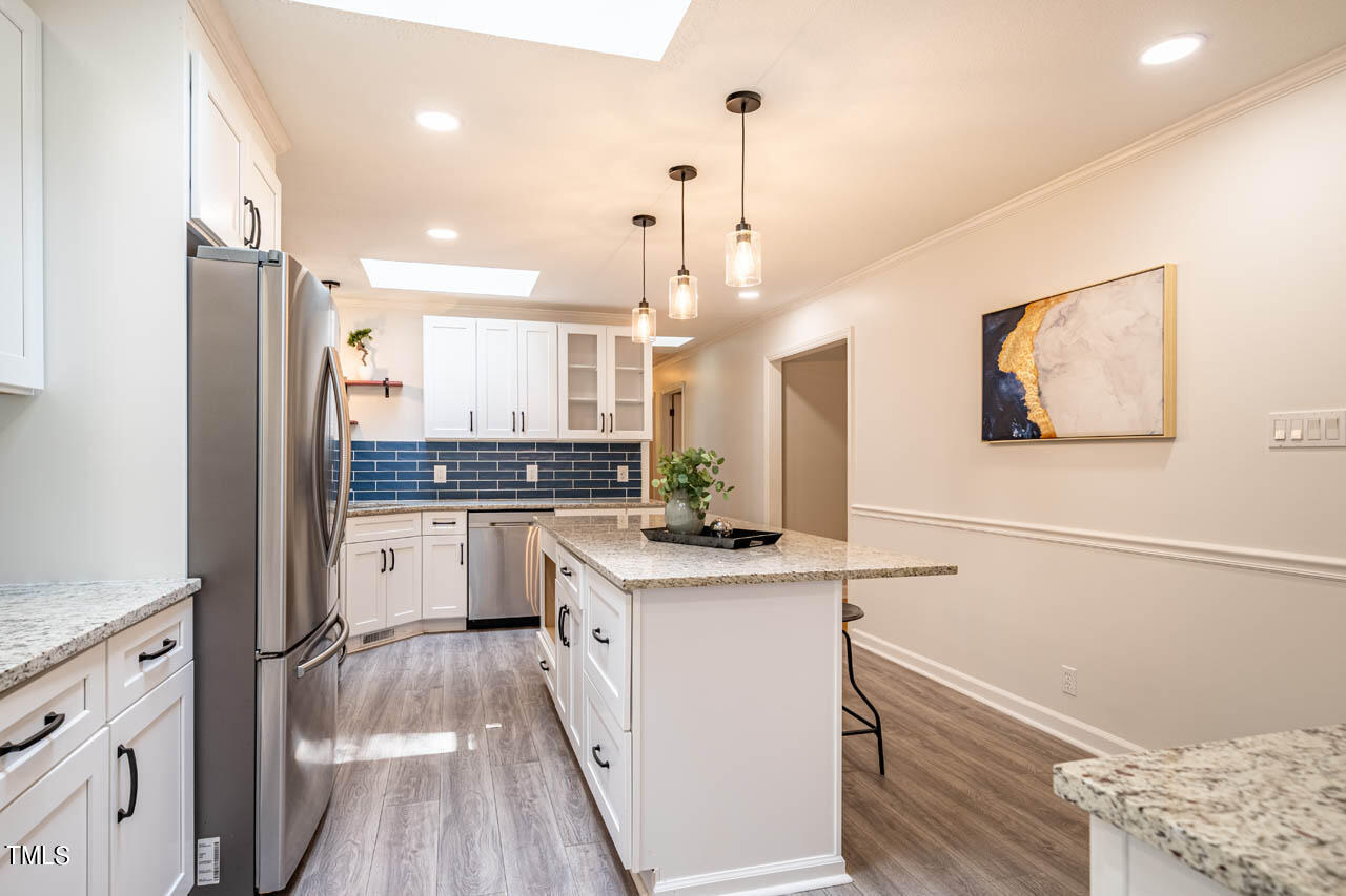 210 Landsbury Drive Durham, NC 27707 - Photo 8 of 20 a kitchen with white cabinets and stainless steel appliances
