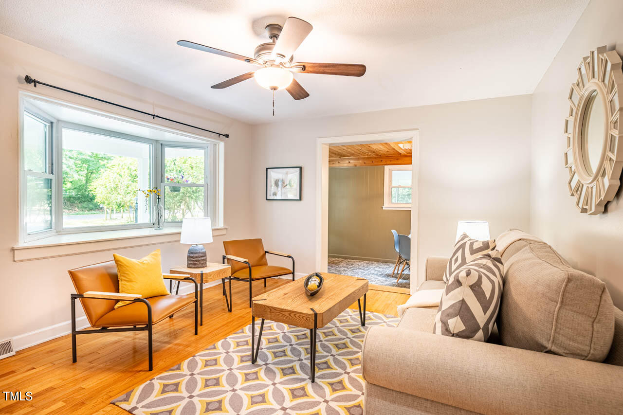 210 Landsbury Drive Durham, NC 27707 - Photo 10 of 20 a living room with furniture and a large window