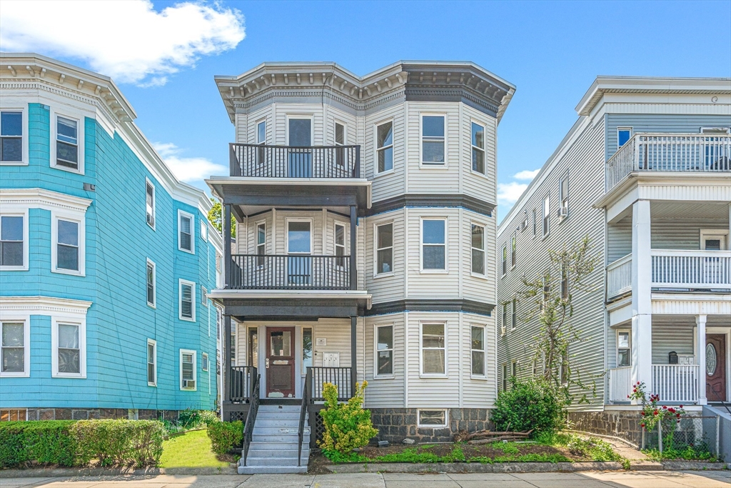 79 Pleasant Street Boston, MA 02125 - Photo 1 of 34 a front view of a residential apartment building with a yard