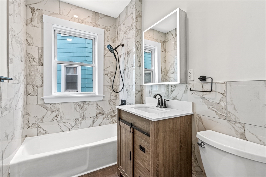 79 Pleasant Street Boston, MA 02125 - Photo 11 of 34 a bathroom with a sink toilet tub and shower
