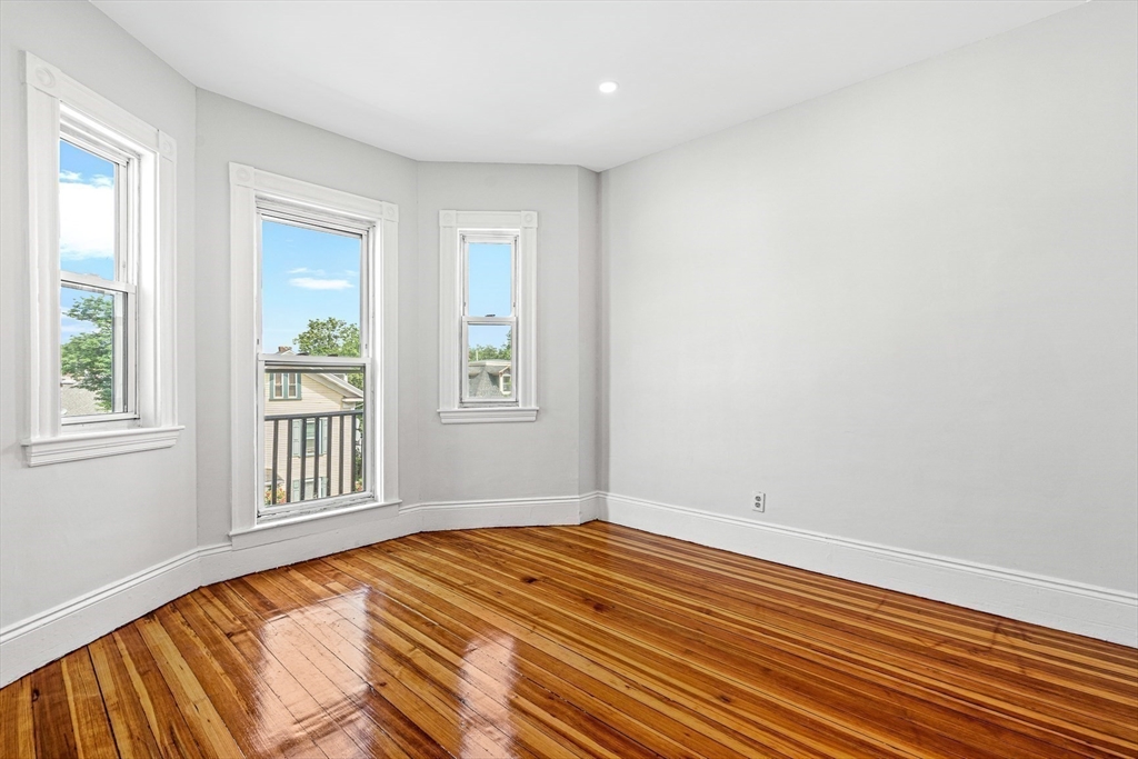 79 Pleasant Street Boston, MA 02125 - Photo 12 of 34 a view of a room with wooden floor and windows