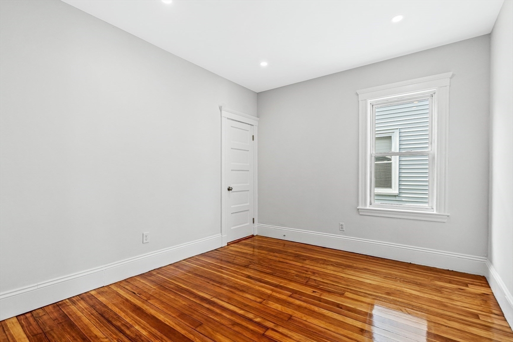 79 Pleasant Street Boston, MA 02125 - Photo 16 of 34 a view of empty room with wooden floor and fan