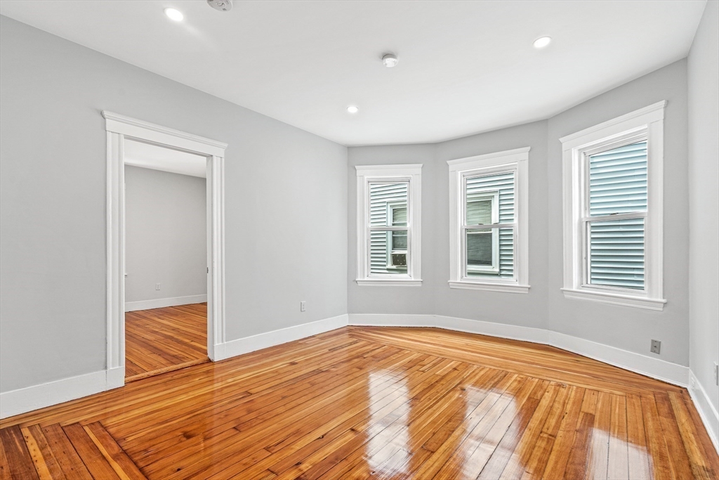 79 Pleasant Street Boston, MA 02125 - Photo 23 of 34 a view of empty room with wooden floor and fan