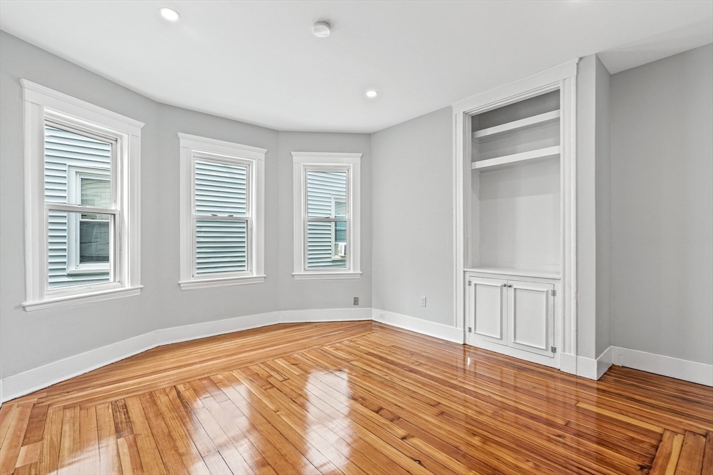 79 Pleasant Street Boston, MA 02125 - Photo 24 of 34 a view of an empty room with wooden floor and a window