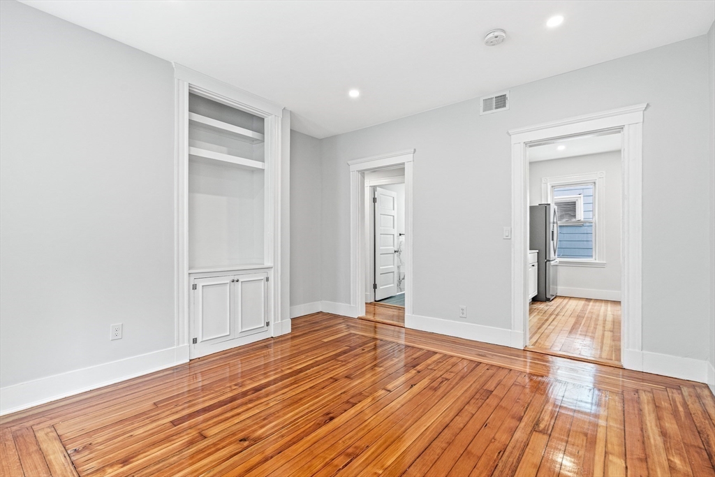 79 Pleasant Street Boston, MA 02125 - Photo 26 of 34 a view of empty room with wooden floor