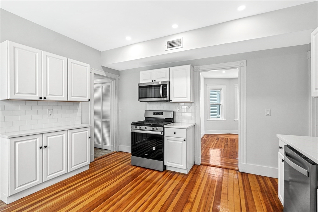 79 Pleasant Street Boston, MA 02125 - Photo 29 of 34 a kitchen with wooden floors and appliances