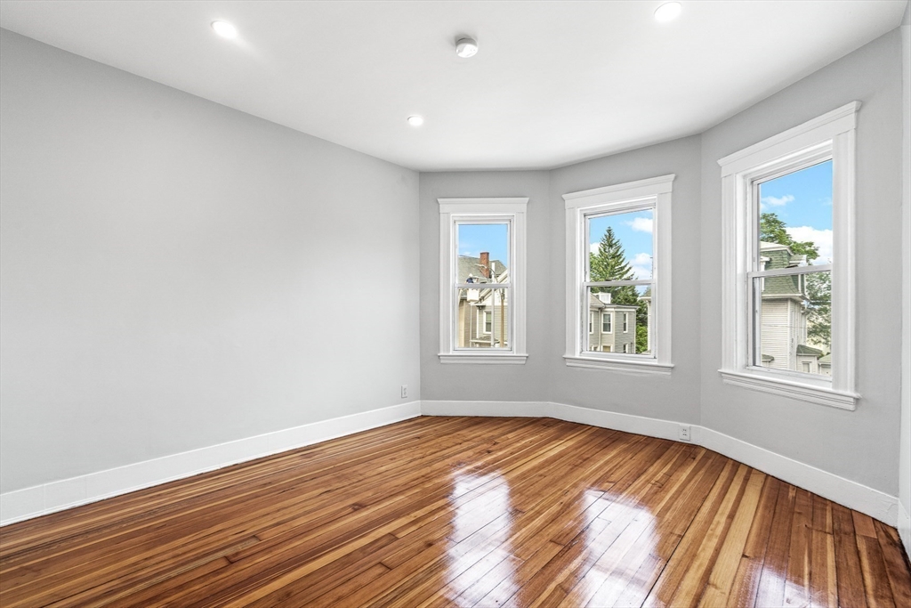 79 Pleasant Street Boston, MA 02125 - Photo 33 of 34 a view of empty room with wooden floor and fan