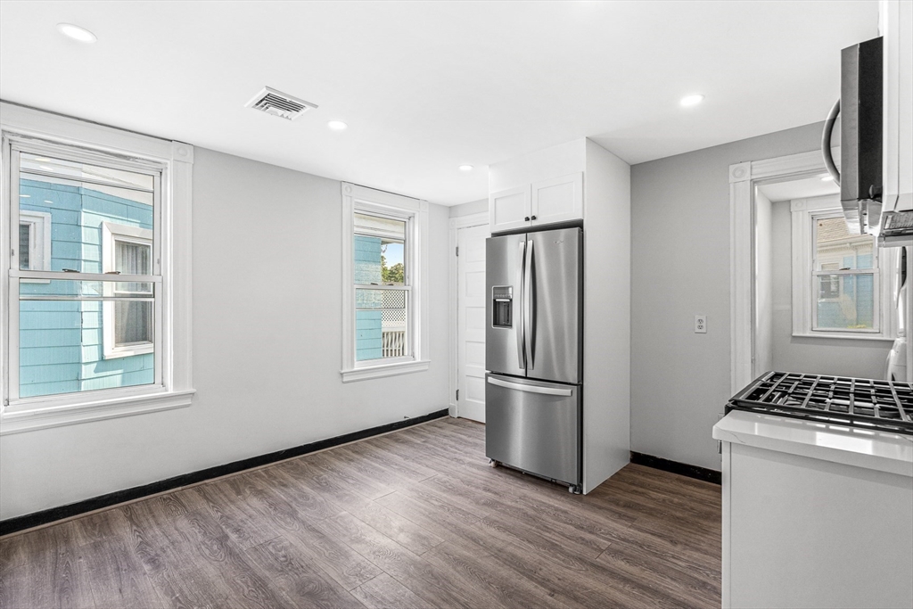 79 Pleasant Street Boston, MA 02125 - Photo 4 of 34 a kitchen with stainless steel appliances a refrigerator and a stove top oven