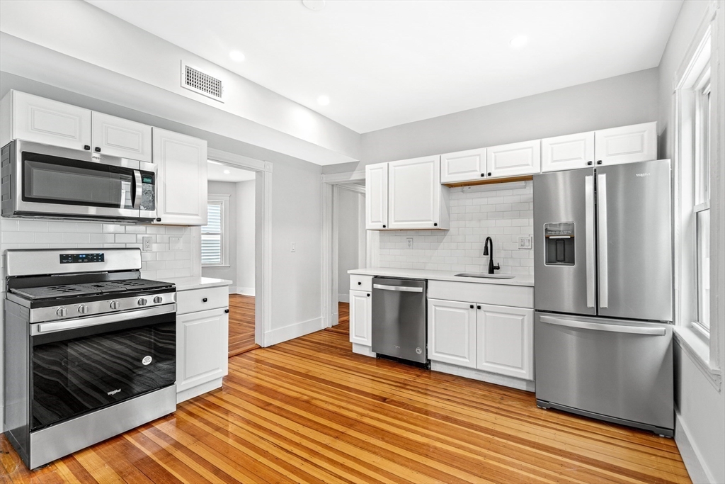 79 Pleasant Street Boston, MA 02125 - Photo 5 of 34 a kitchen with granite countertop a refrigerator stove and microwave