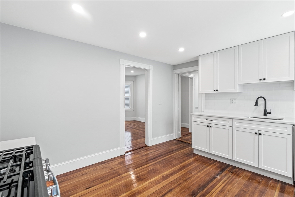 79 Pleasant Street Boston, MA 02125 - Photo 10 of 34 a view of a kitchen with sink and dishwasher with wooden floor