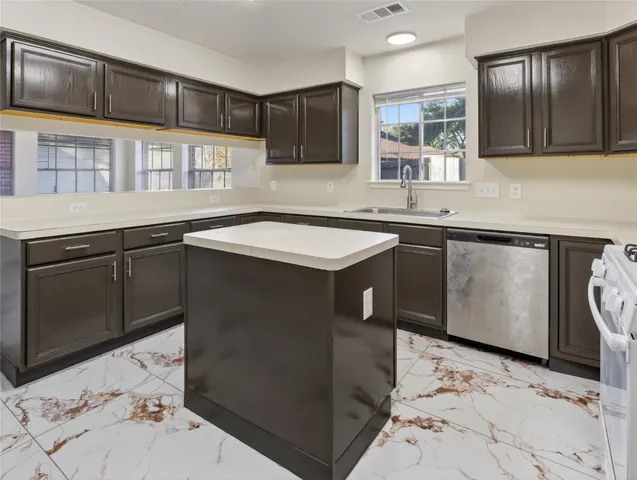 a kitchen with a sink stove and cabinets