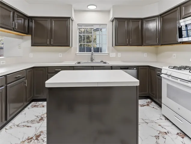 a kitchen with a sink stove and cabinets