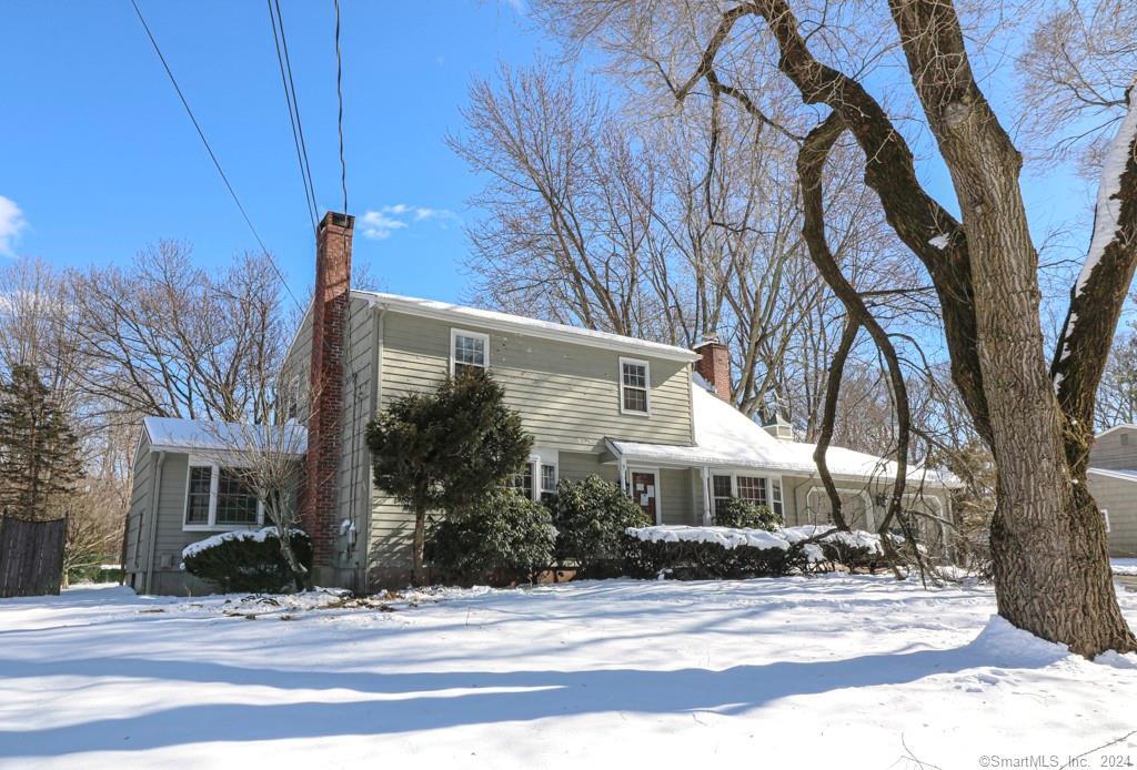 107 Exeter Road Hamden, CT 06518 - Photo 1 of 1 a front view of a house with yard and tree s