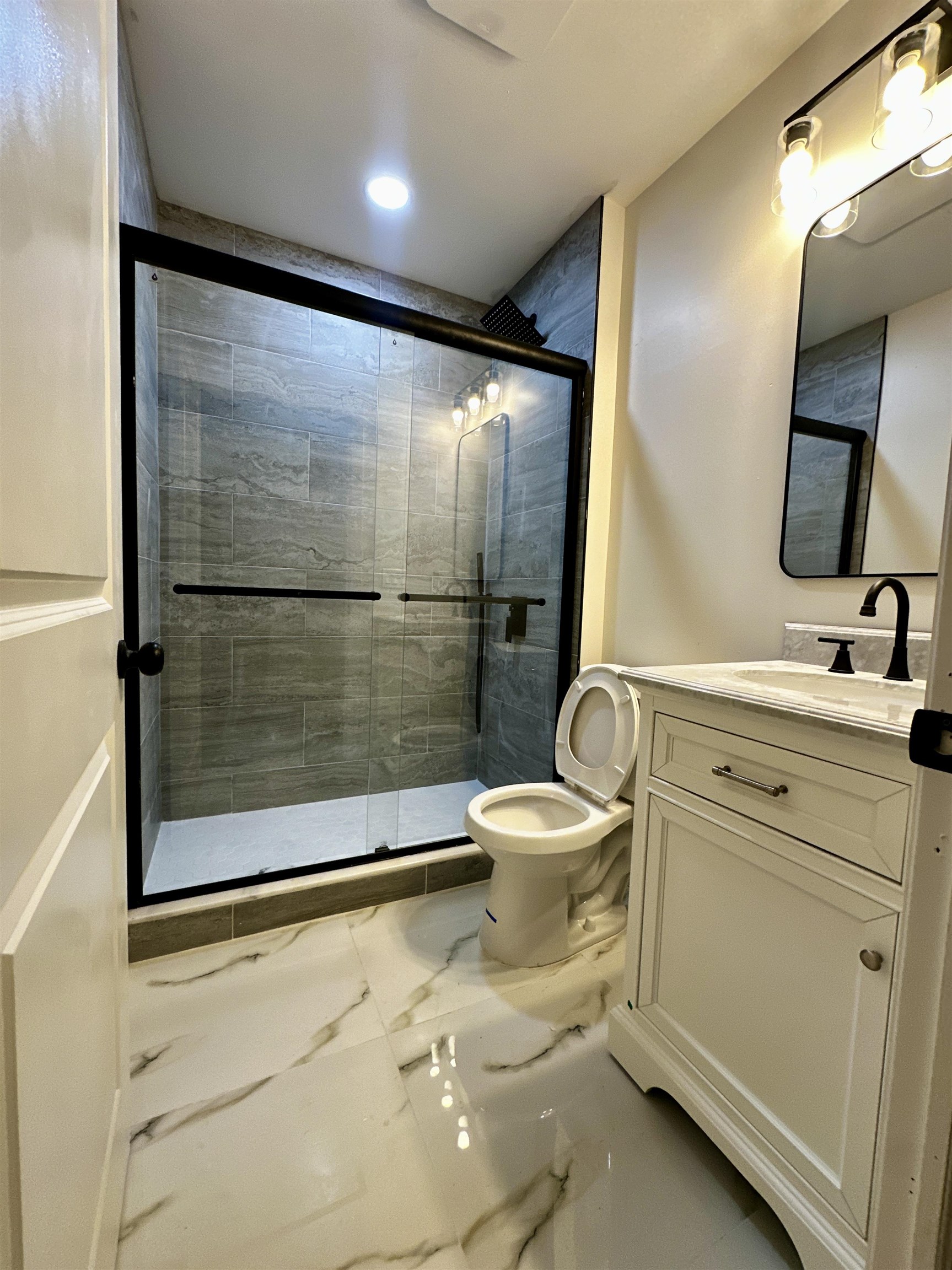 188 Heckel Street, Unit 1 Belleville, NJ 07109 - Photo 4 of 13 a bathroom with a sink toilet and shower