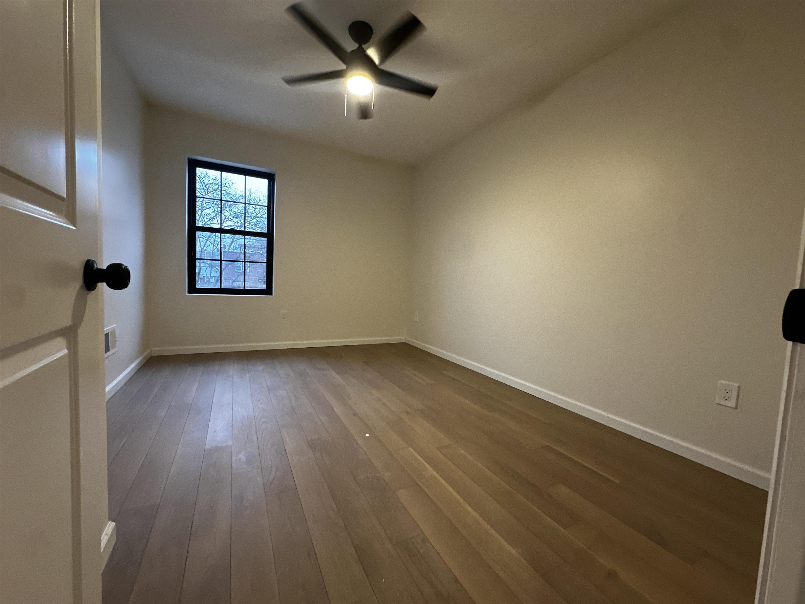188 Heckel Street, Unit 1 Belleville, NJ 07109 - Photo 7 of 13 wooden floor in an empty room with a window