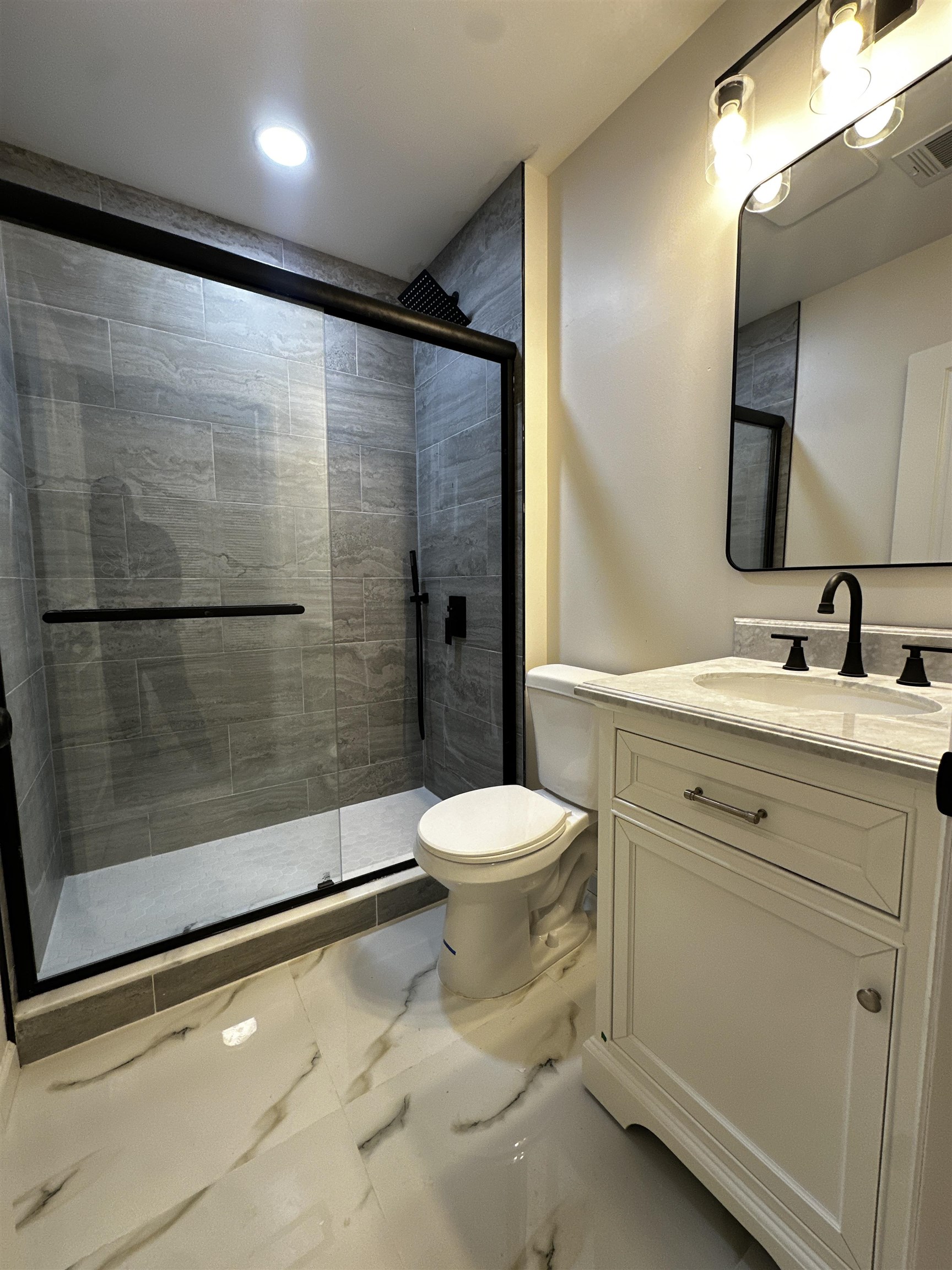 188 Heckel Street, Unit 1 Belleville, NJ 07109 - Photo 9 of 13 a bathroom with a sink toilet and shower