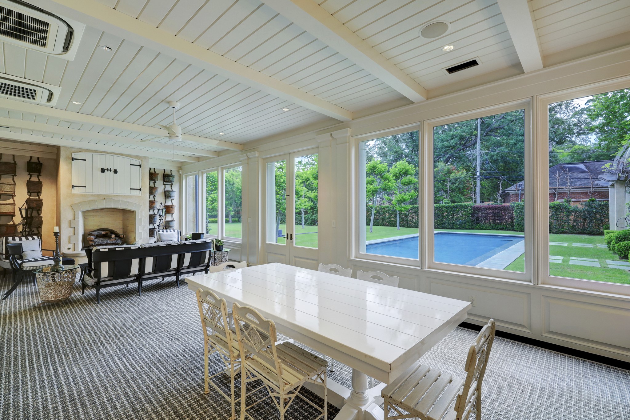 3 Briarwood Court Houston, TX 77019 - Photo 17 of 50 Fireplace and views from the screened porch. Note the AC units at ceiling. The room can be cooled if needed. Dutch door access to family stair alcove and foyer to breakfast room.