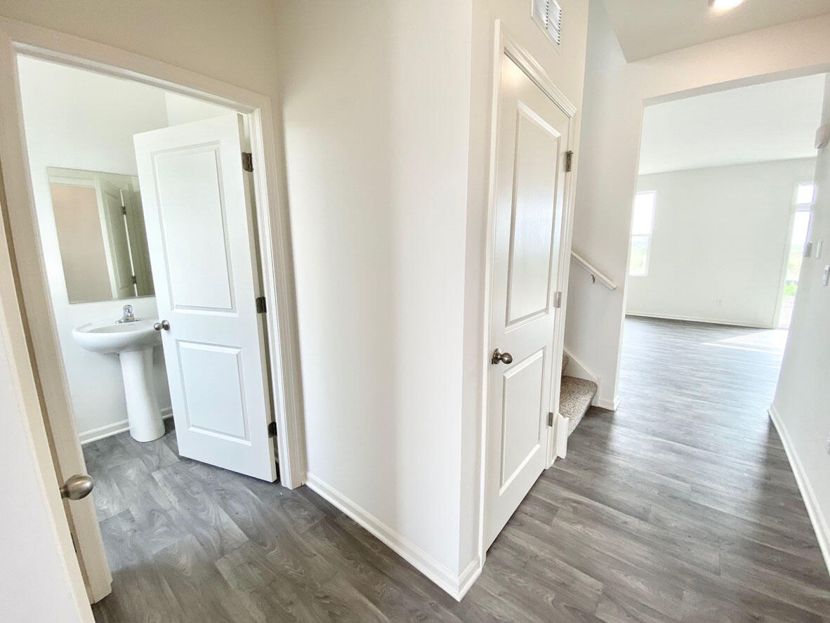 587 Osburn Street Hebron, IN 46341 - Photo 3 of 18 a view of a hallway with wooden floor and a bathroom