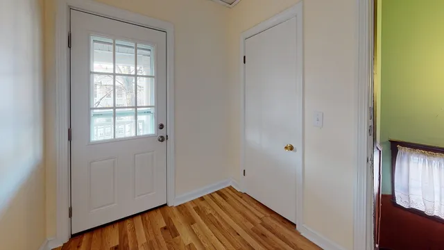 a view of front door with wooden floor