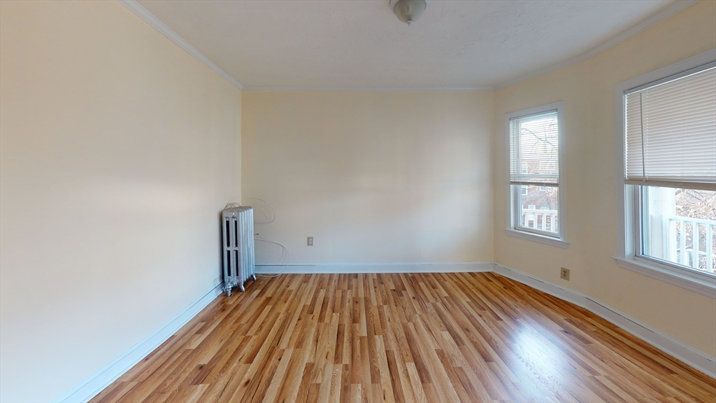 5 Edgar Terrace, Unit 3 Somerville, MA 02145 - Photo 5 of 8 a view of a room with wooden floor and window