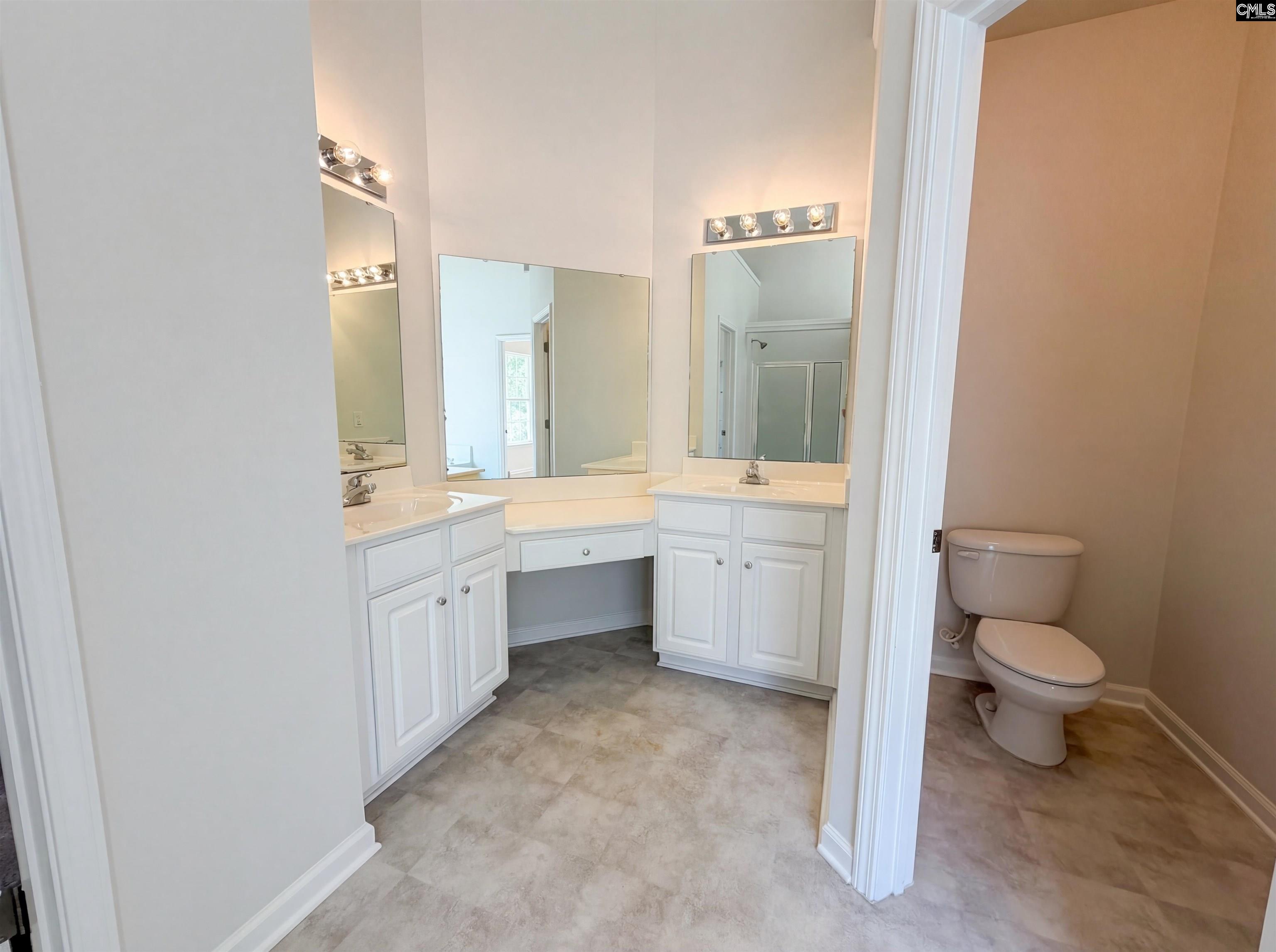 112 Coopers Hawk Circle Irmo, SC 29063 - Photo 21 of 26 a bathroom with a double vanity sink toilet a mirror and bathtub